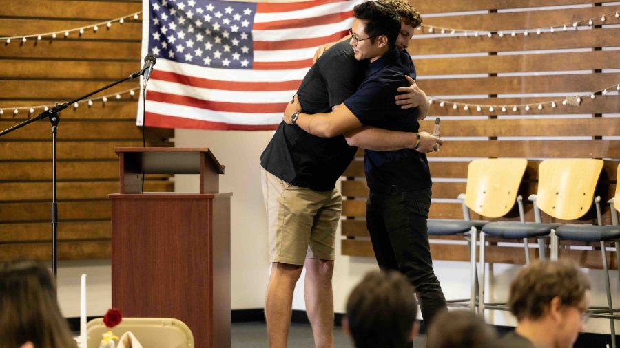 Military veterans hug at the Warrior Breakfast.