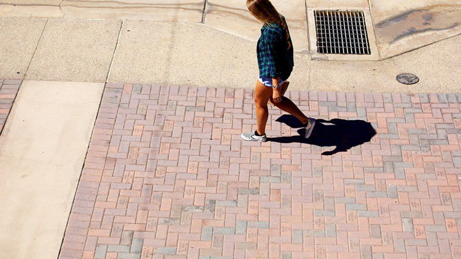 A student walks down the Campus Mall