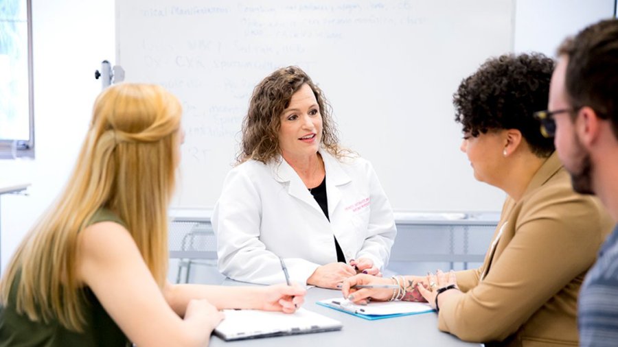 A nurse talking to students about the 4 advanced practice (APRN) careers in nursing. 