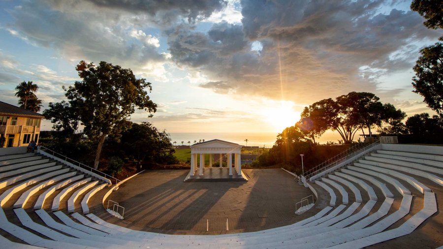 The PLNU Greek with the sun setting behind it