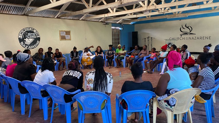 A group of Kenyan women gather in a meeting at a church