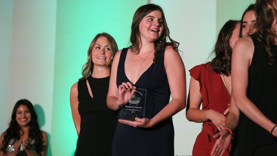 PLNU women's soccer team players receive their team award at the inaugural SLAM awards