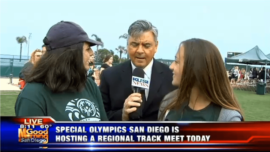 Newscaster interviewing students for Special Olympics