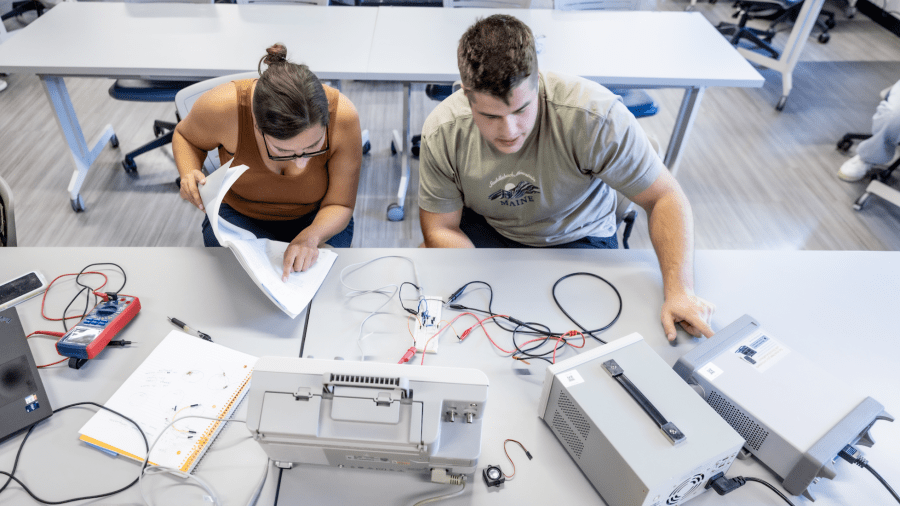 PLNU students work together on technical project in the engineering lab on the university campus.