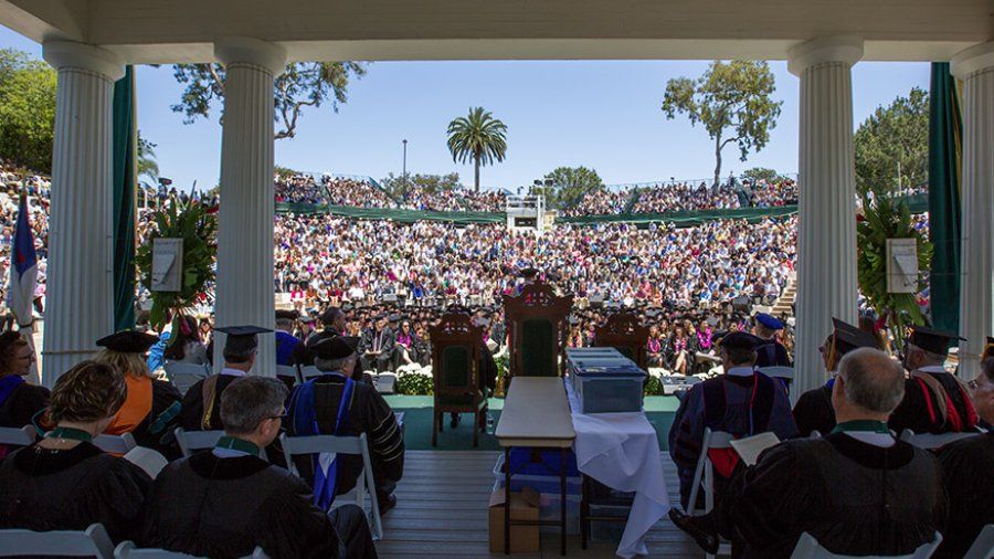 A view from the Greek Amphitheatre toward the crowd of family and friends gathering for commencement