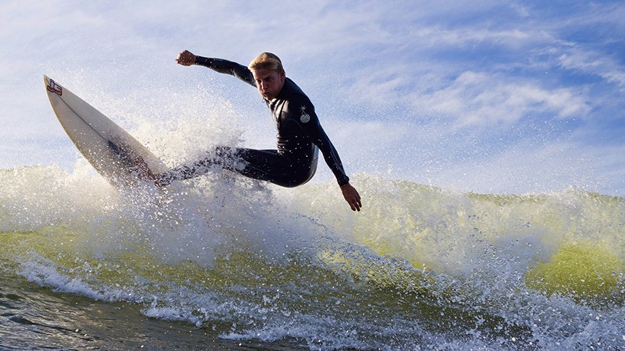 Quay Snyder performs a turn on a wave with his surfboard.