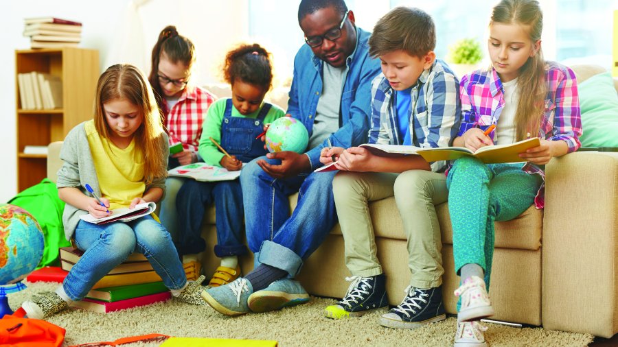 children reading with a teacher