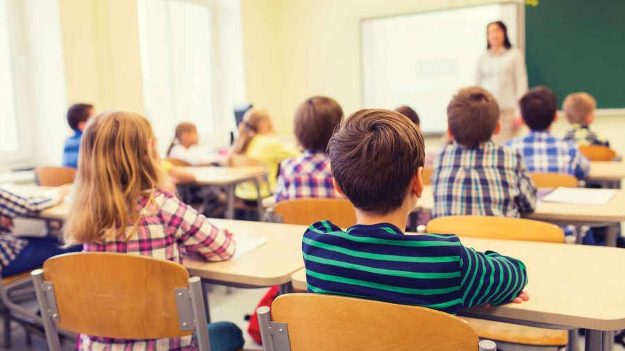 Children sit in a classroom during instruction