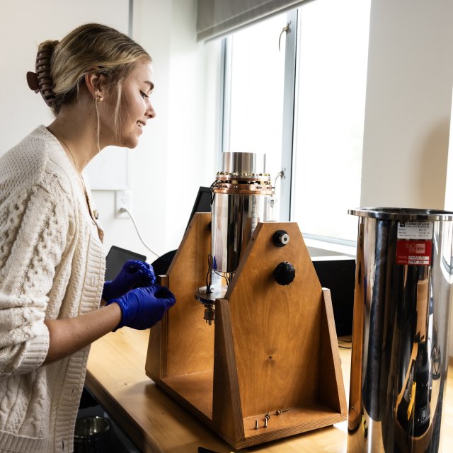 PLNU engineering student analyzes a laboratory testing apparatus during a hands-on engineering project.