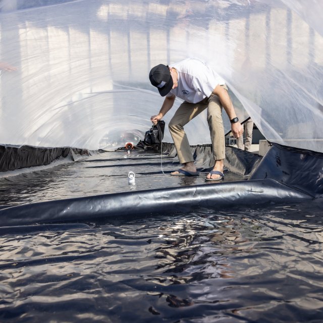 PLNU engineering student collects measurements inside a large-scale experimental testing structure during a senior engineering design project.