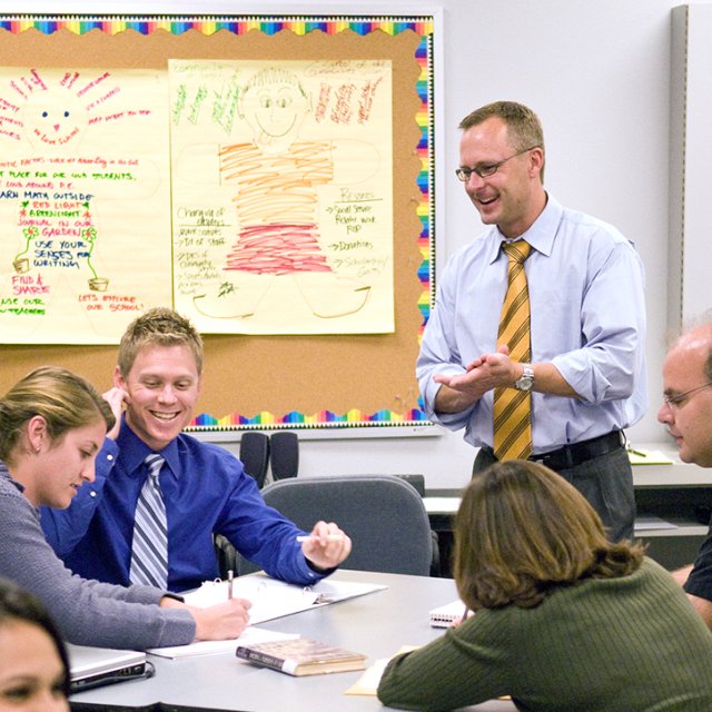 A teacher interacts with his students in the classroom.