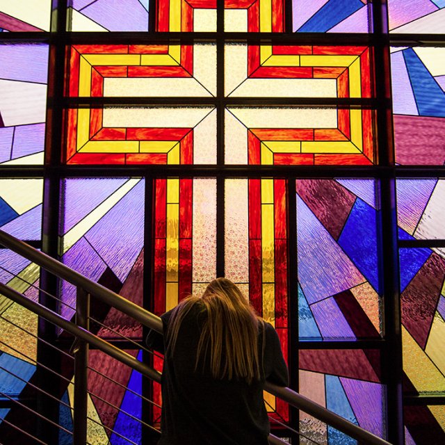 A student prays in Smee Hall