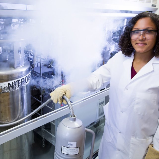 Jasmine Myles in a Lab Coat Conducting Research