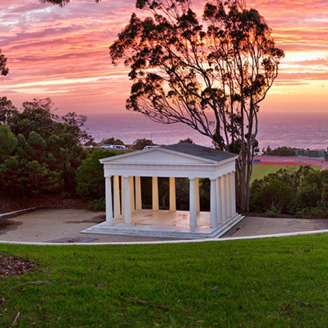 Orange and purple sunset in San Diego is framed by the iconic Greek Amphitheater on PLNU's campus