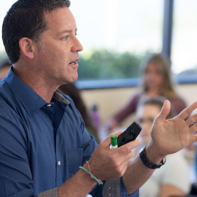 PLNU business professor Randal Schober teaching class about management