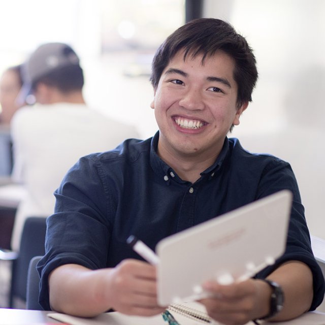 Psychology student smiling while engaged in fieldwork