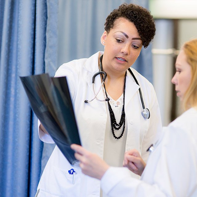 Christina Kelley analyzes a x-ray of a patient she is taking care of.