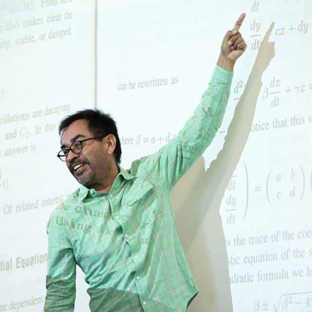 Professor Jesus Jimenez works on a math problem in class
