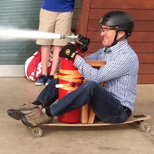 Myles Vandegrift propels himself on a longboard by shooting air out of a gas chamber.