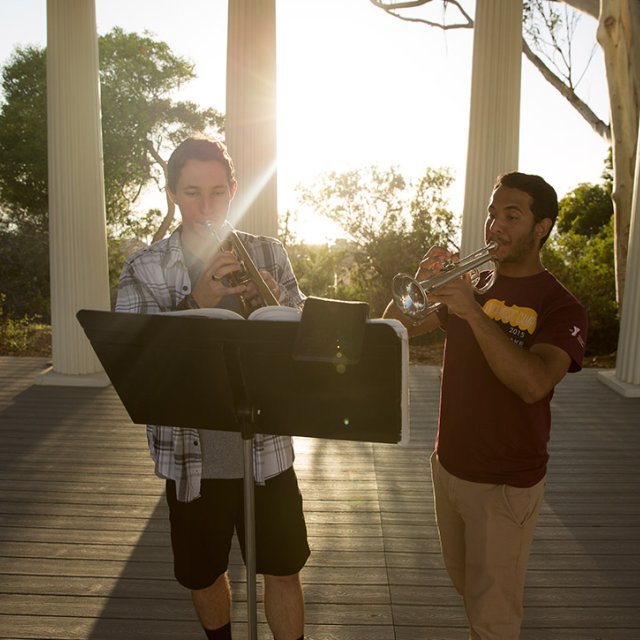 Two students play their instruments in the Greek