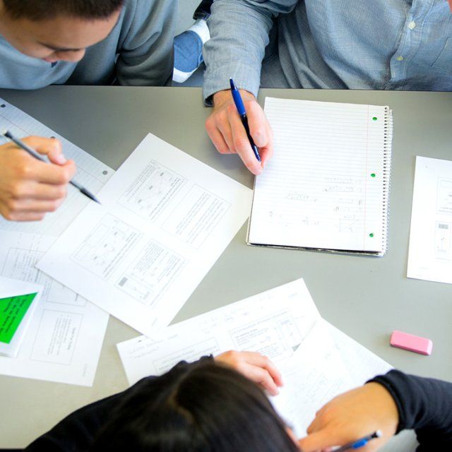 A group of students work on their assignment in class.