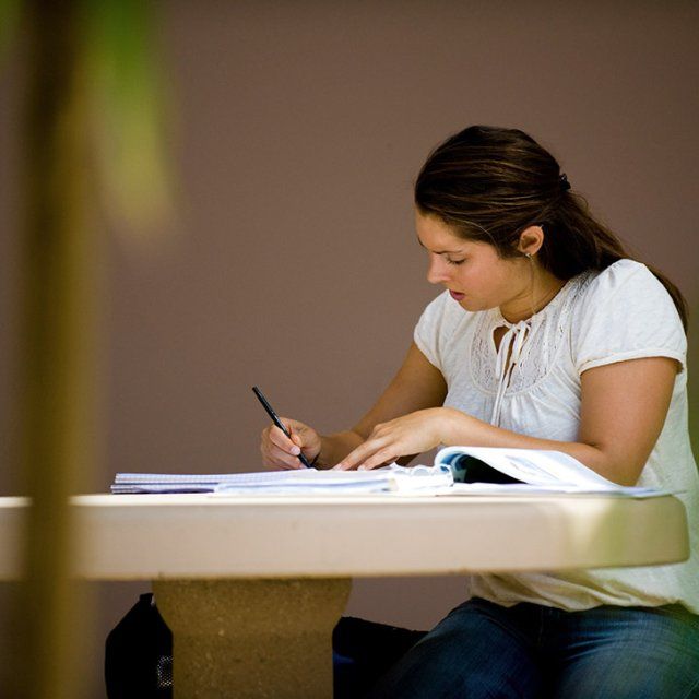 A student works on homework outside