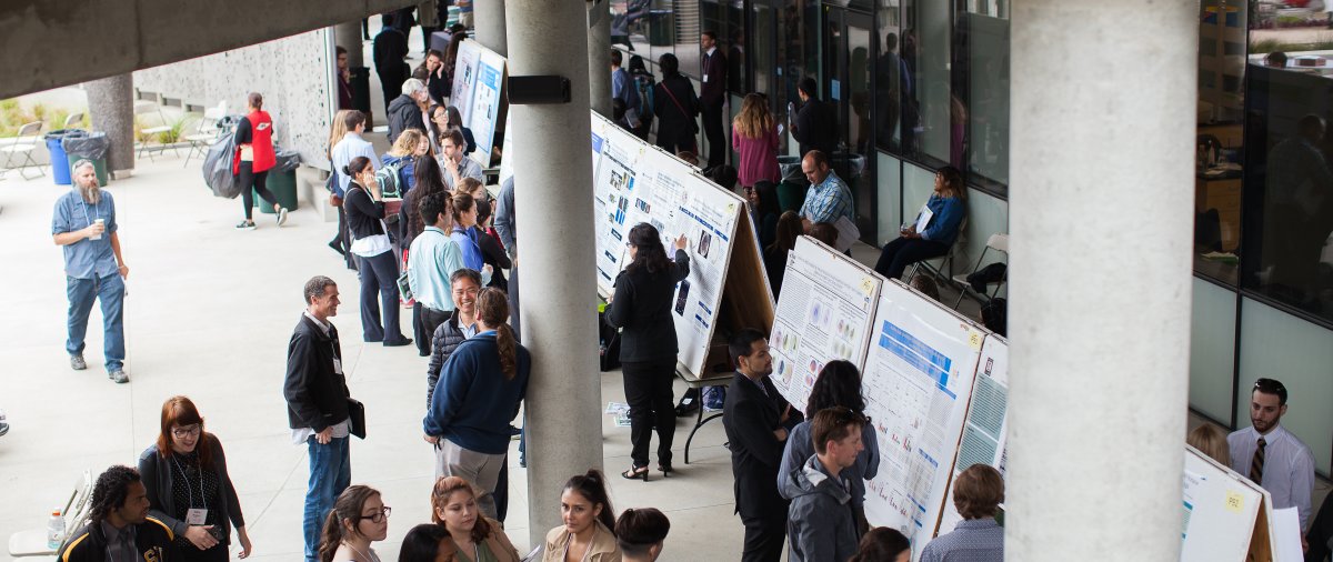 Students and researchers discuss scientific posters during the West Coast Biological Sciences Undergraduate Research Conference at PLNU.