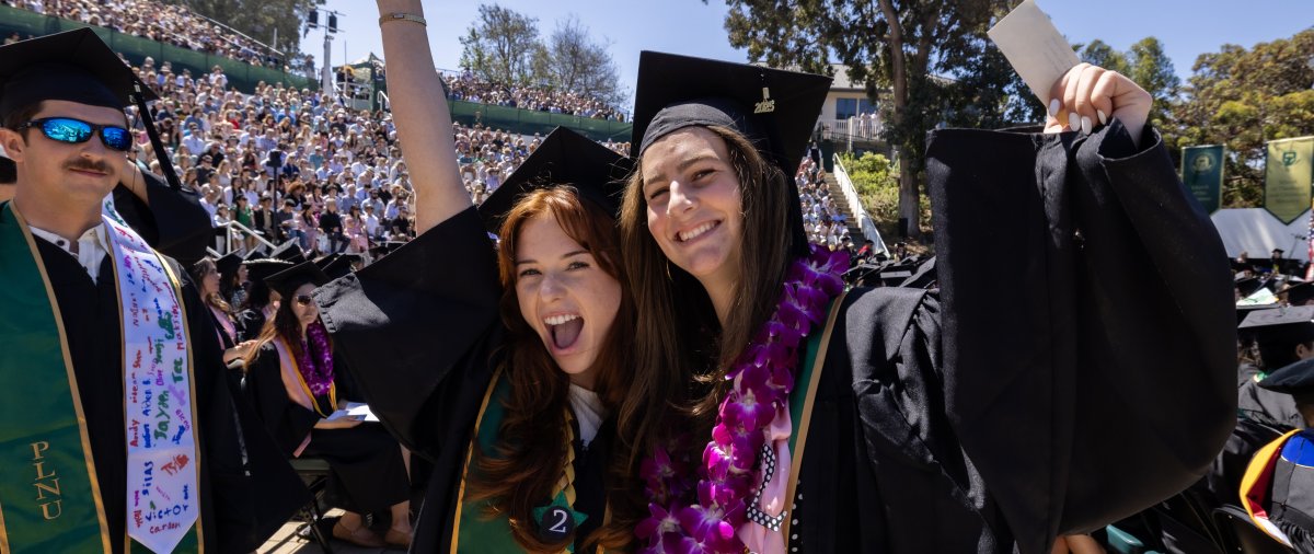PLNU students pose together in celebration at commencement.