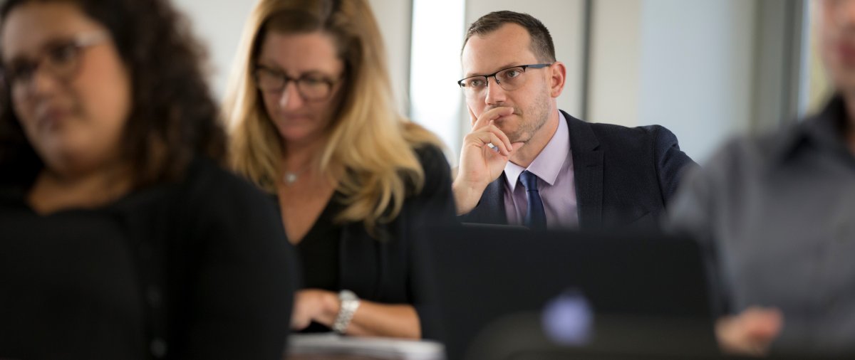 Male graduate student in class