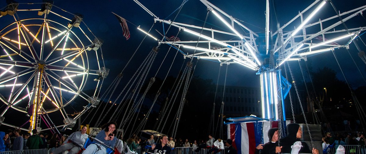 Students ride a chair merry go round carnival ride
