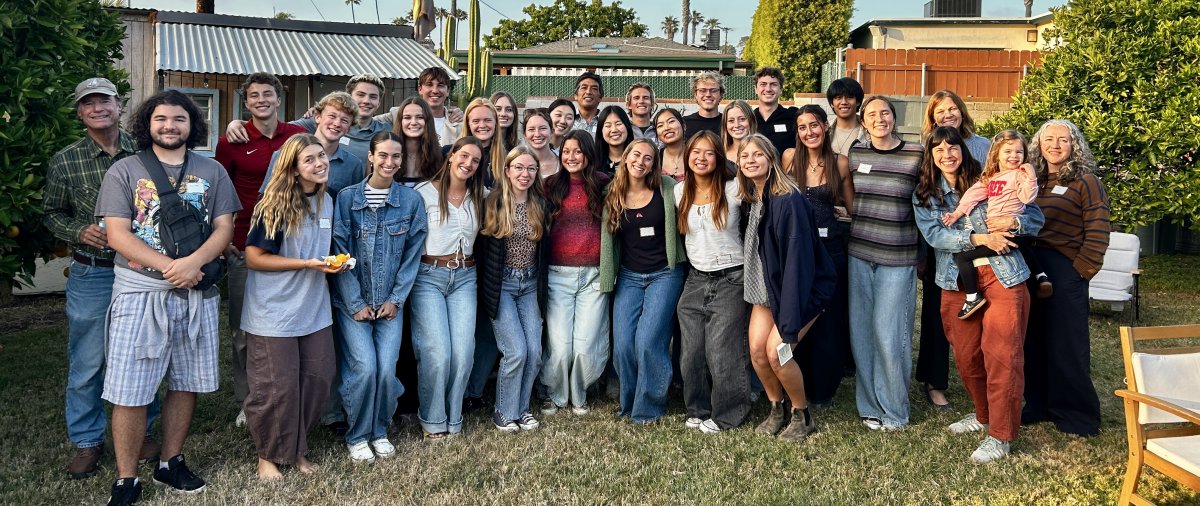 PLNU honors program students and faculty pose for a group photo during an outdoor gathering.