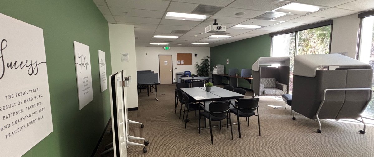 Computer lab space at the PLNU Mission Valley campus with desk, computers, and sitting space available for students.