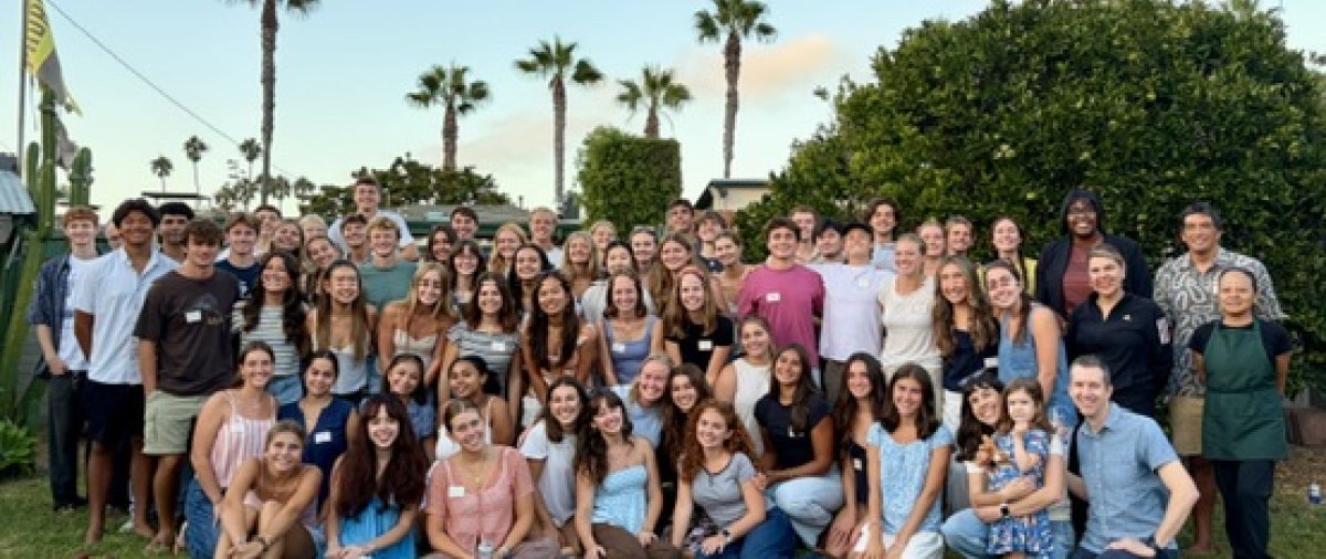 Students, faculty, and staff gather outdoors for a group photo at PLNU’s 2026 Welcome Dinner.