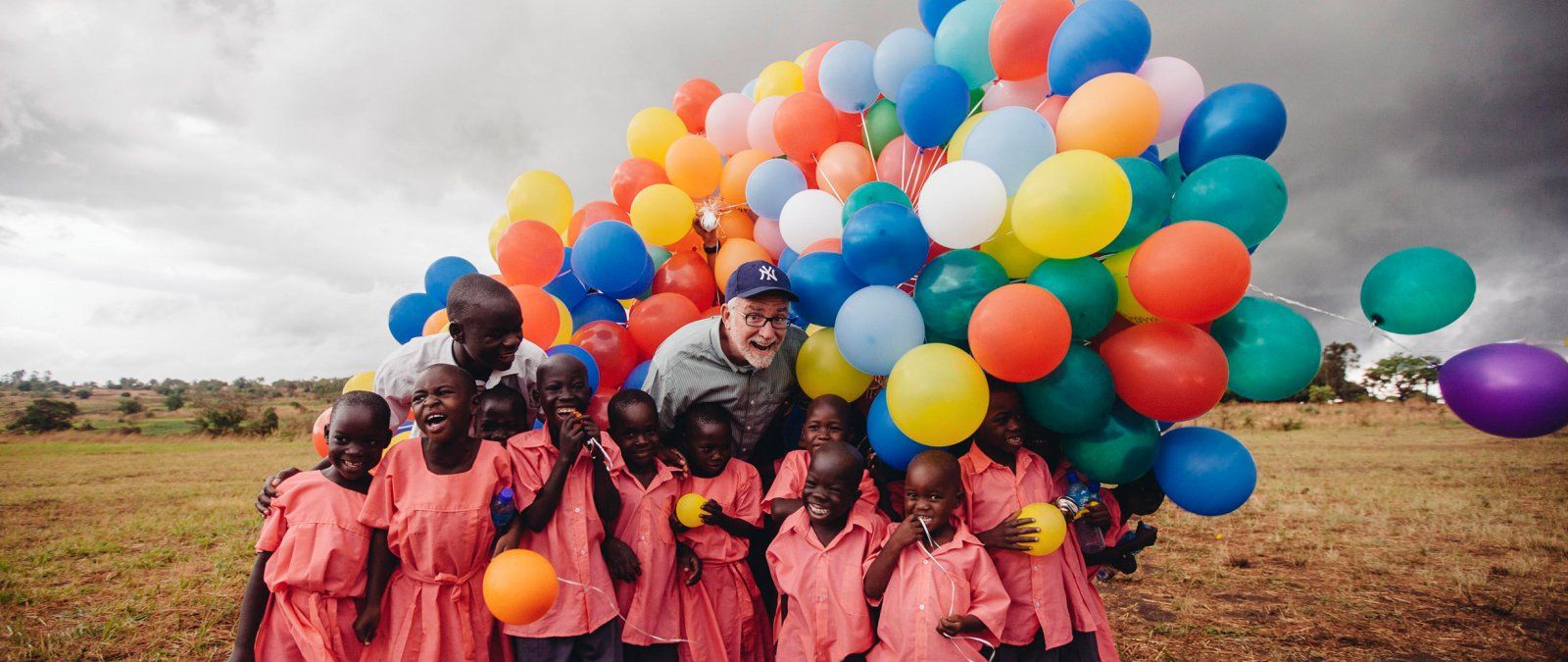 Bob Goff brings a large collection of colorful balloons to his Love Does students in Uganda