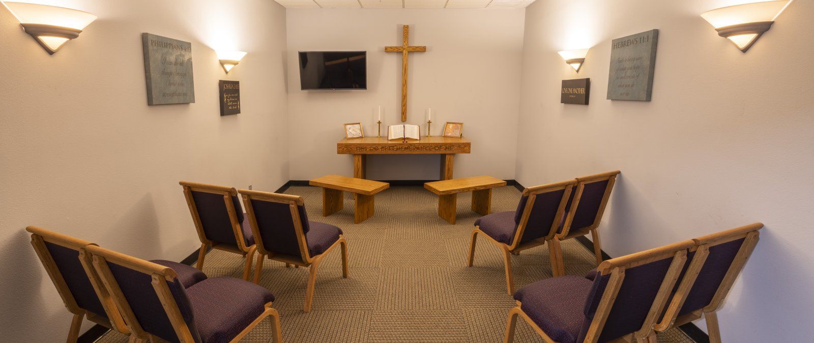 Chapel room with chairs, benches and an alter