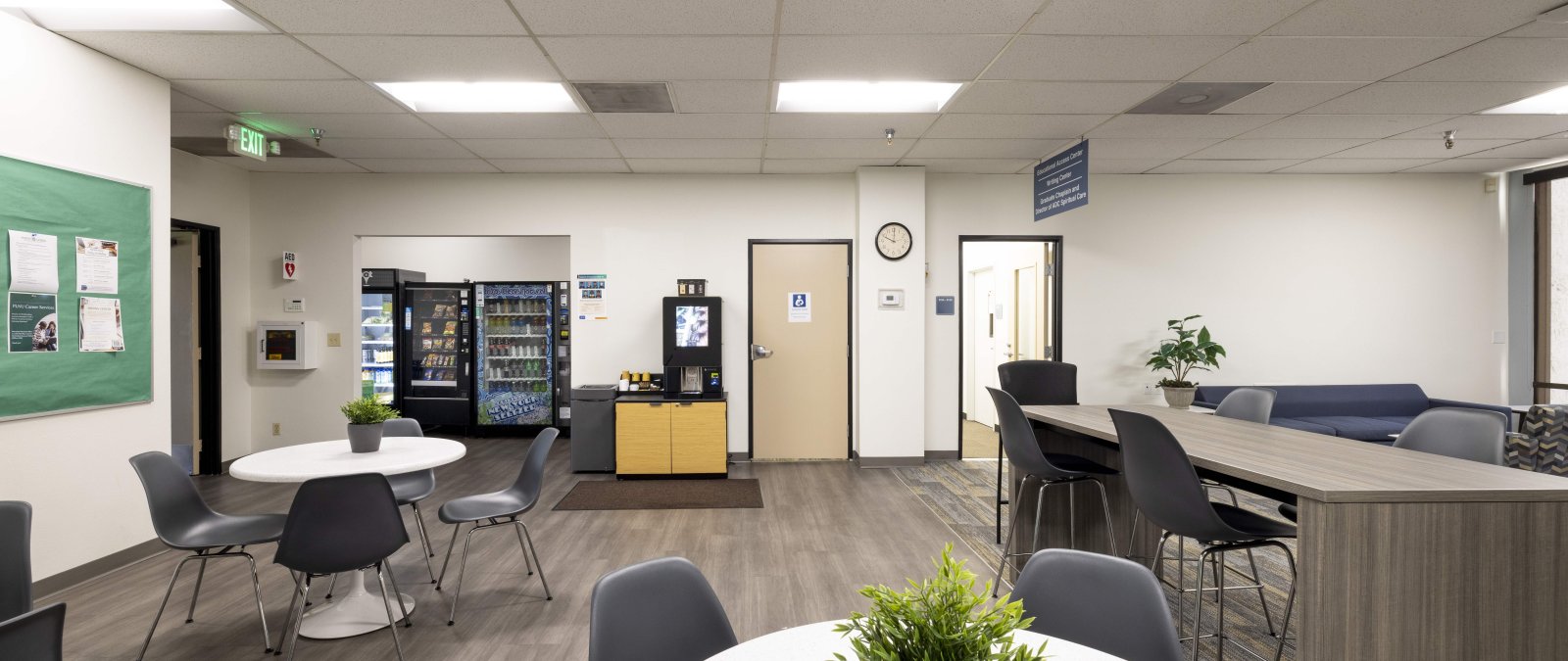 Lounge area with tables, chairs, vending machines, coffee area and a lactation room