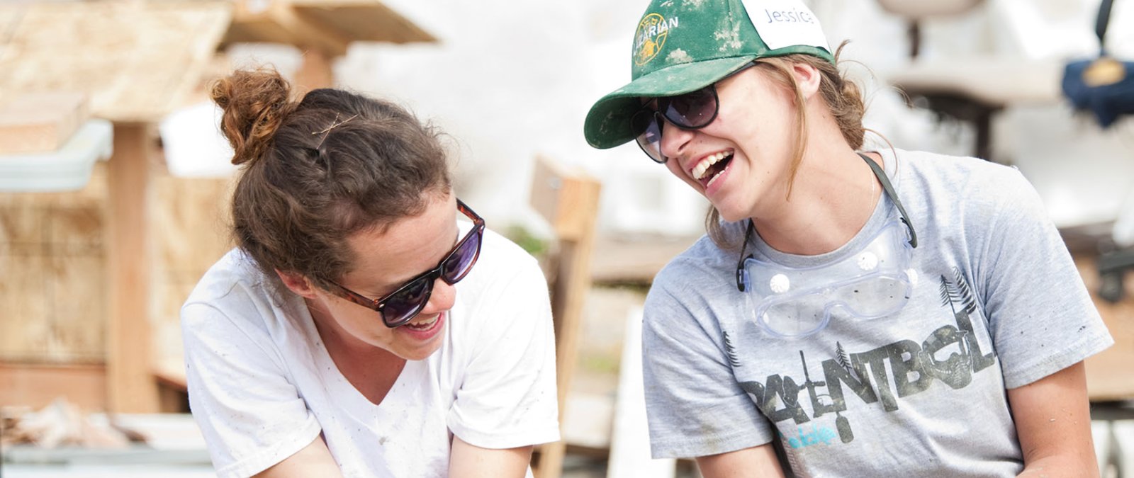 Two female students take a break during a home building project in Mexico with La Iglesia ministries