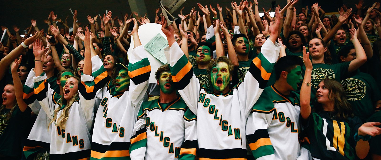 The student section, the Green Sea cheers loudly for the basketball team.