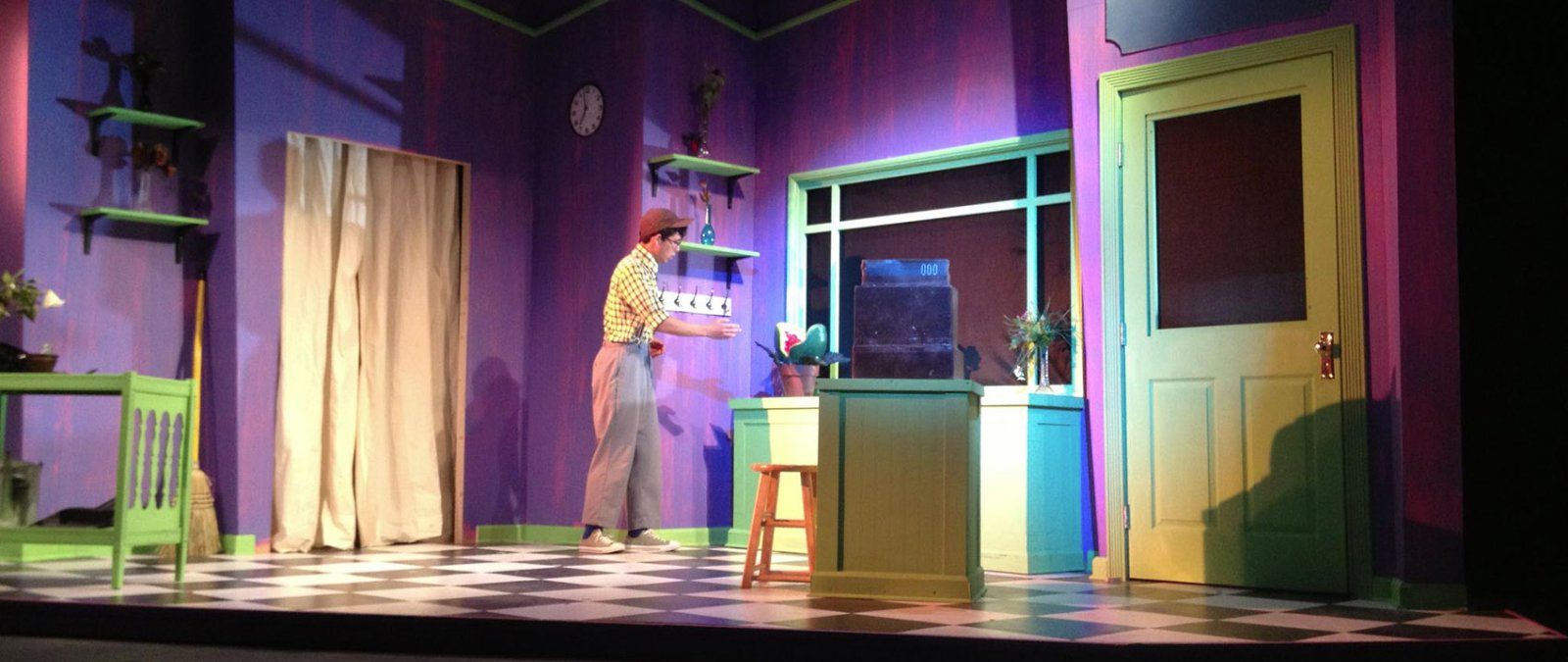 Male actor cautiously approaching sink while acting in Little Shop of Horrors