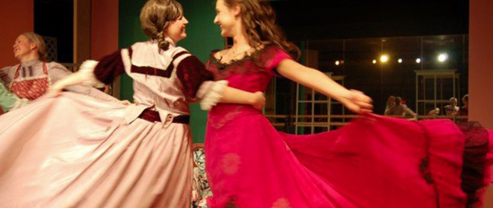Two actresses dancing joyfully while acting in "Little Women"