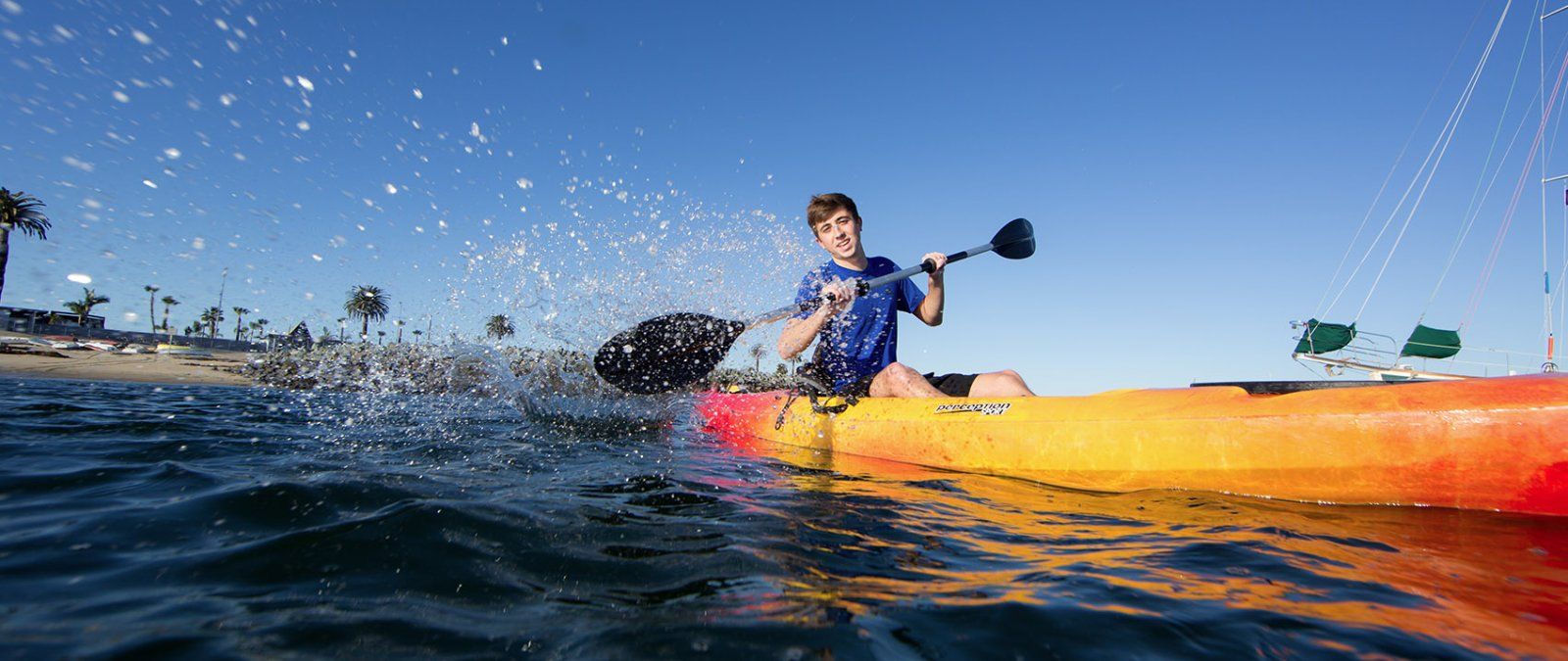 A student kayaks in the San Diego Bay.