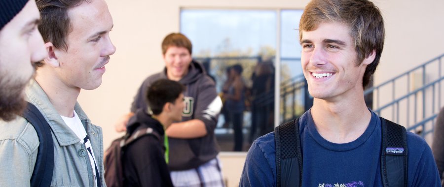 PLNU undergraduate degree seeking students bond together during a class break.