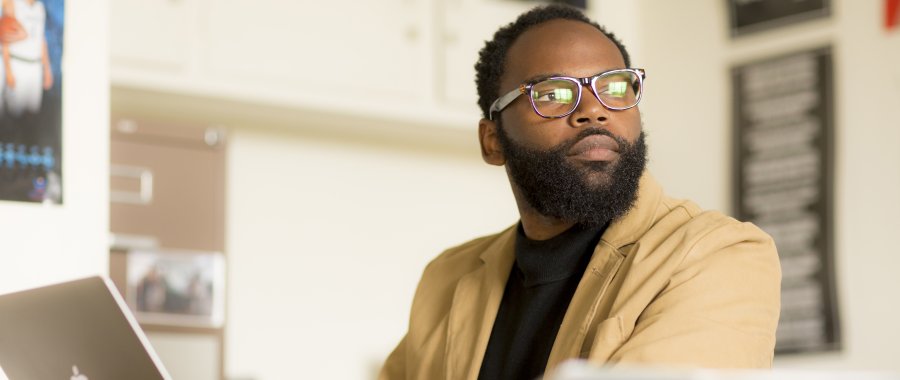 Education student looks up from his work in PLNU's Education bachelor's and master's degree programs.