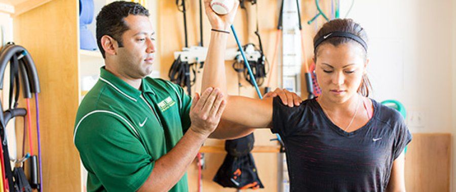 Kinesiology student helps with physical therapy as part of PLNU's bachelor's and master's degree options in kinesiology.