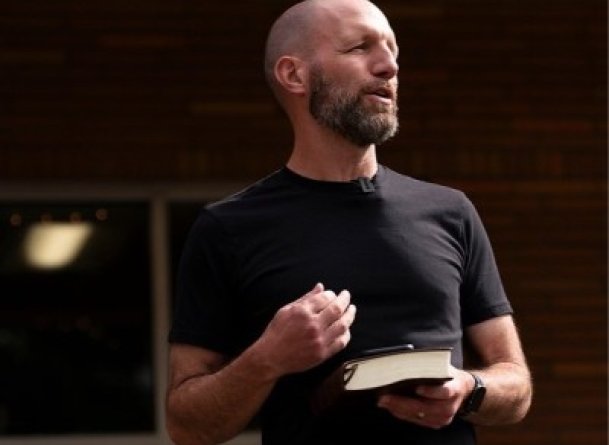 Dr. Jamie Johnson preaches holding the Bible