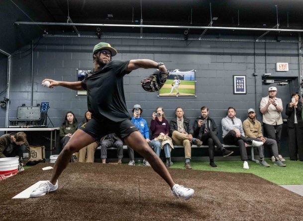 PLNU pitcher steps to throw a pitch at the Biomechanics Lab