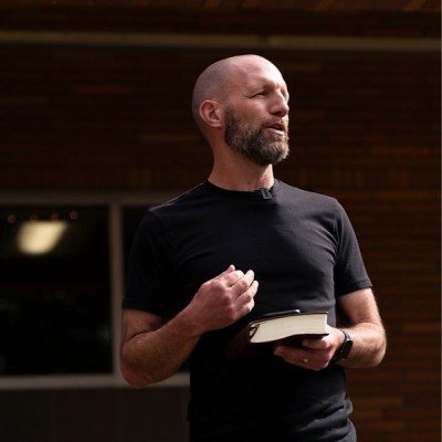Dr. Jamie Johnson preaches holding the Bible