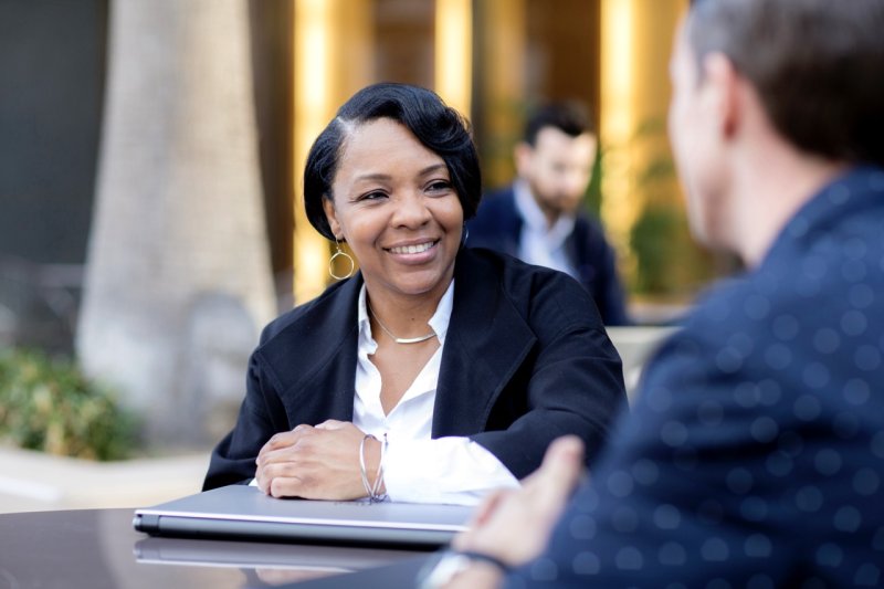 Adult business students talking at a table