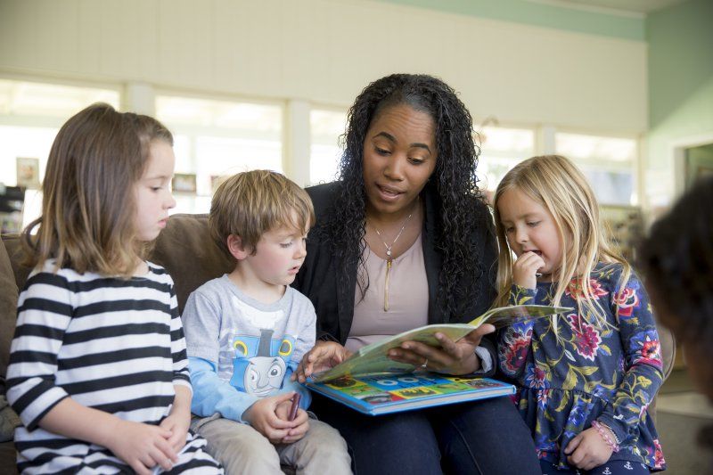 Woman reading to kids 
