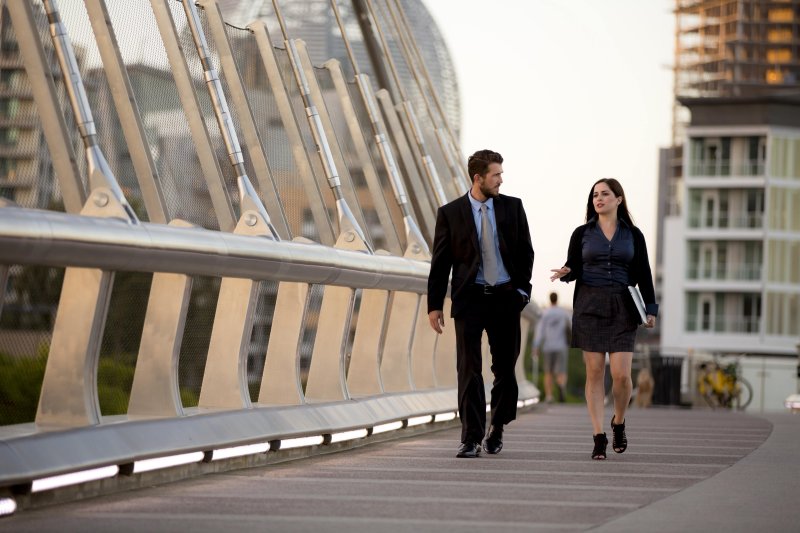 Two adults walking and talking 